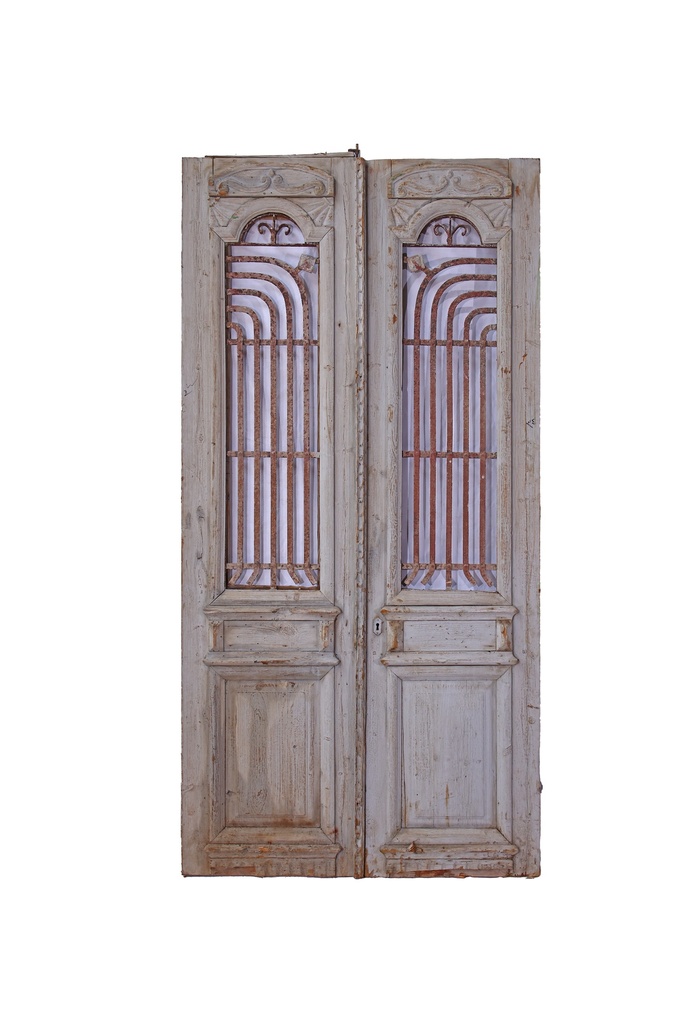 A door with a wrought iron grille